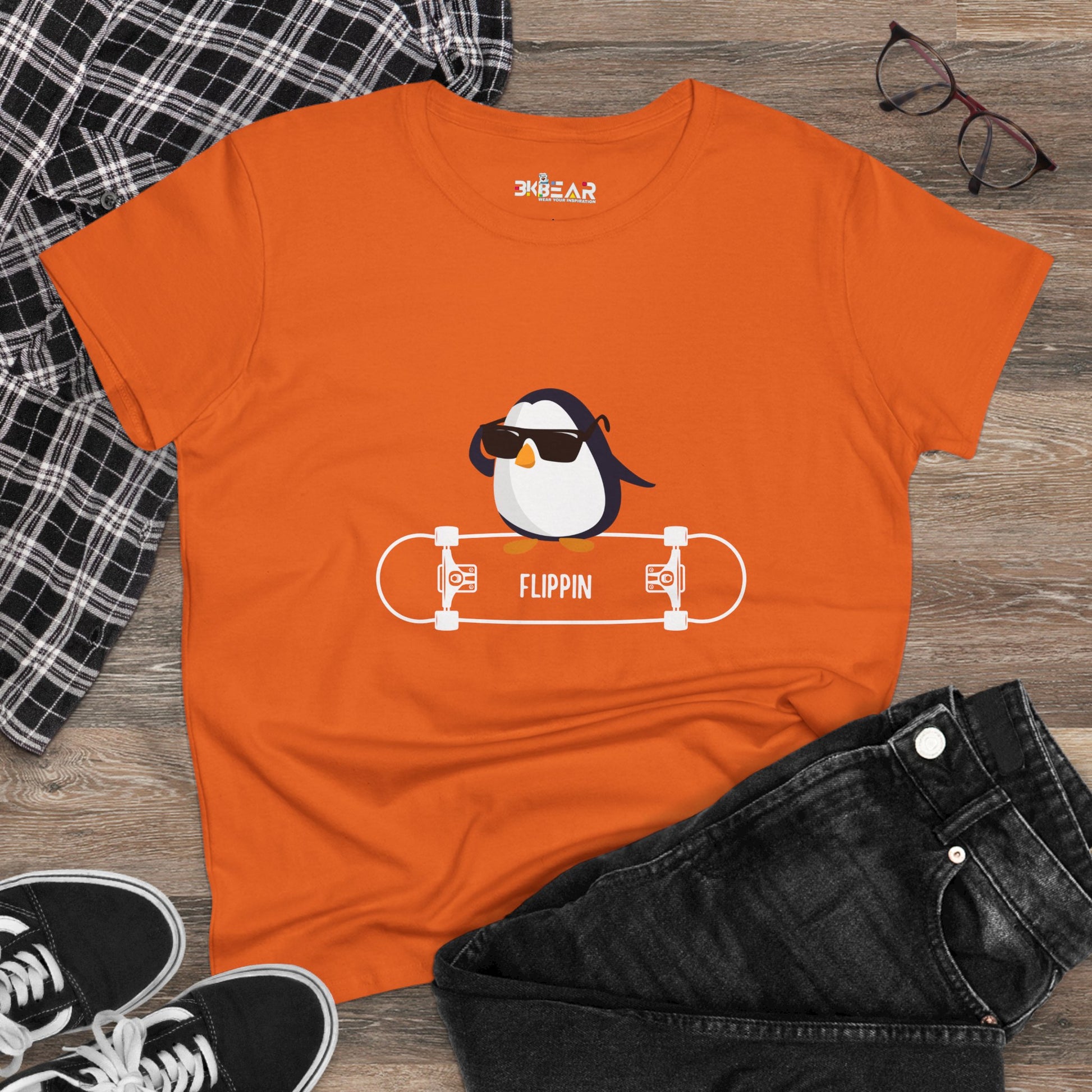 Orange Adélie penguin tee from Printify featuring a cool penguin with sunglasses on a skateboard