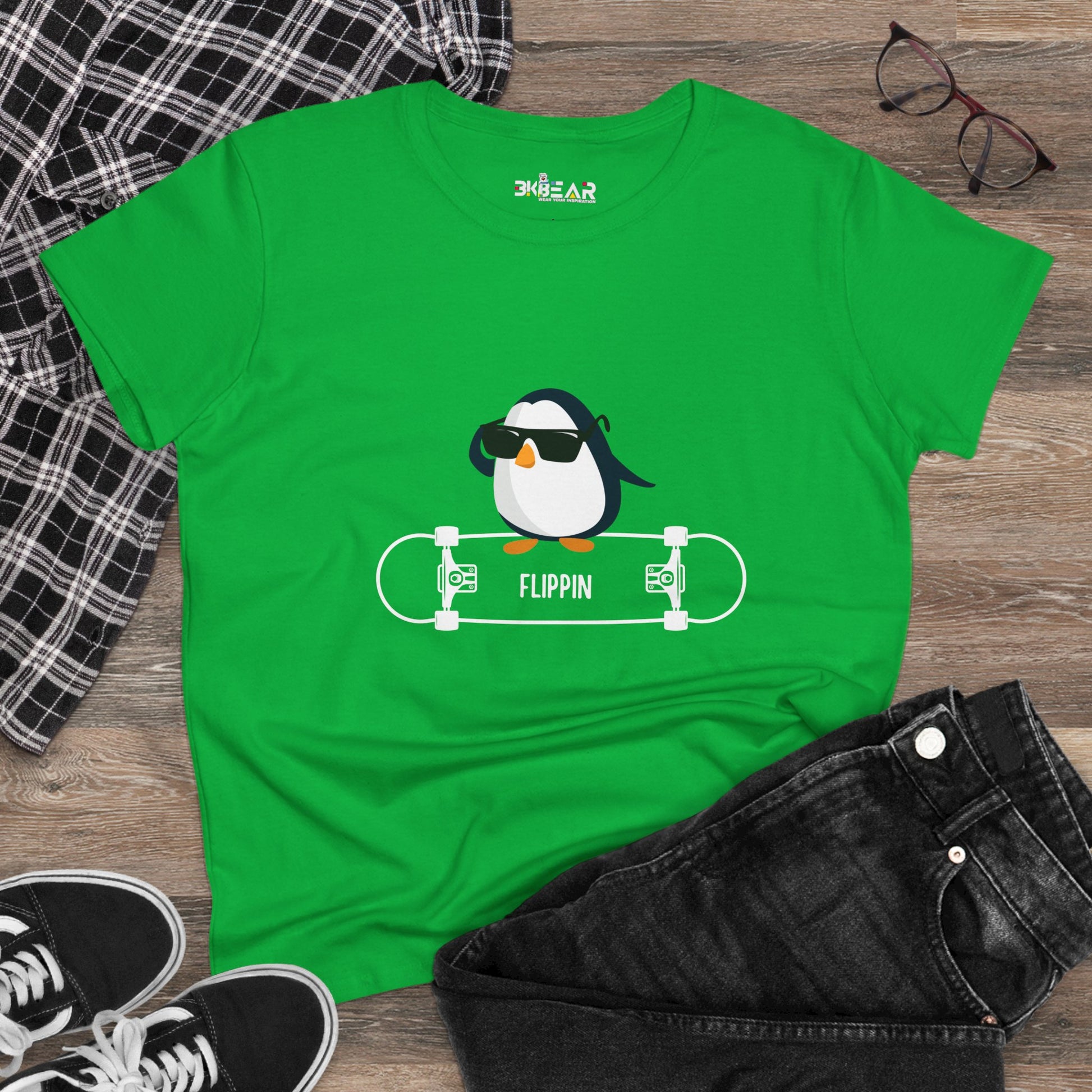 Green Adélie penguin tee with cool penguin graphic wearing sunglasses on skateboard by Printify