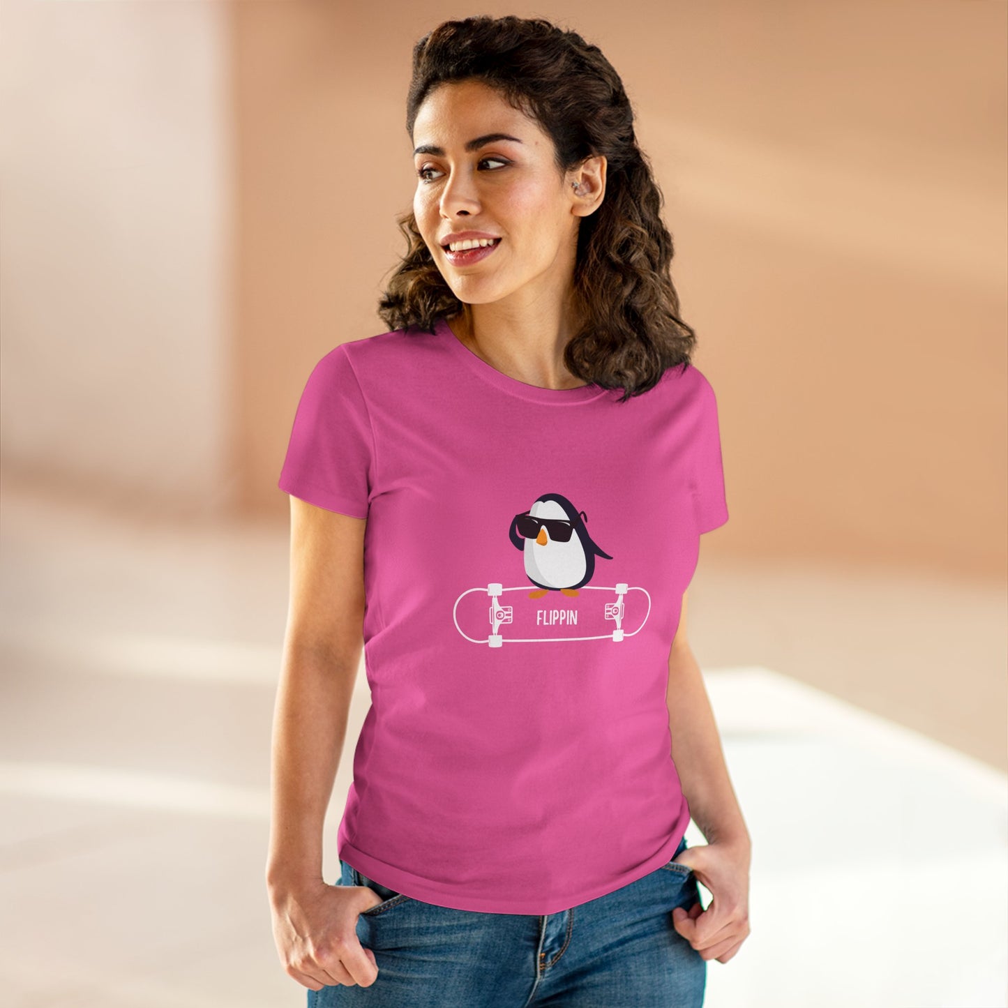 Woman wearing a pink Adélie penguin tee with a cool penguin on skateboard graphic by Printify