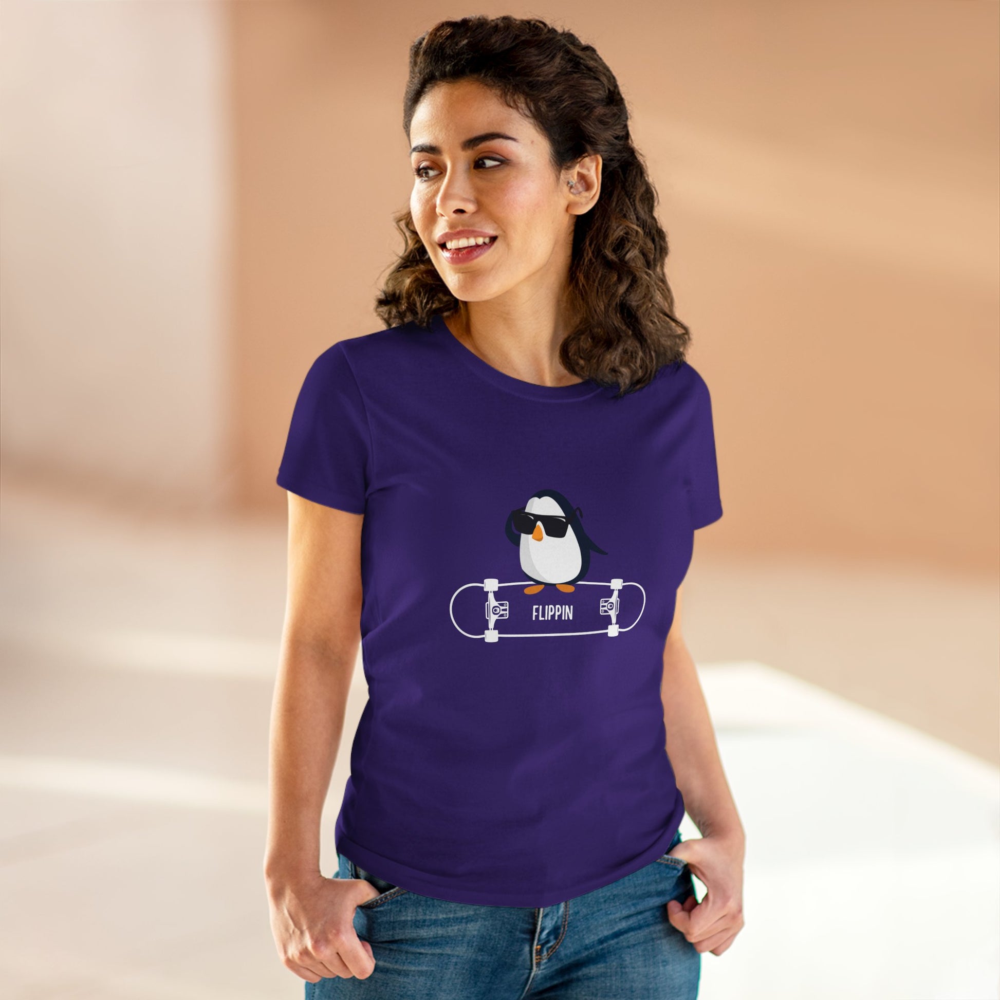 Woman wearing a purple Adélie penguin tee featuring a cool penguin with sunglasses on a skateboard