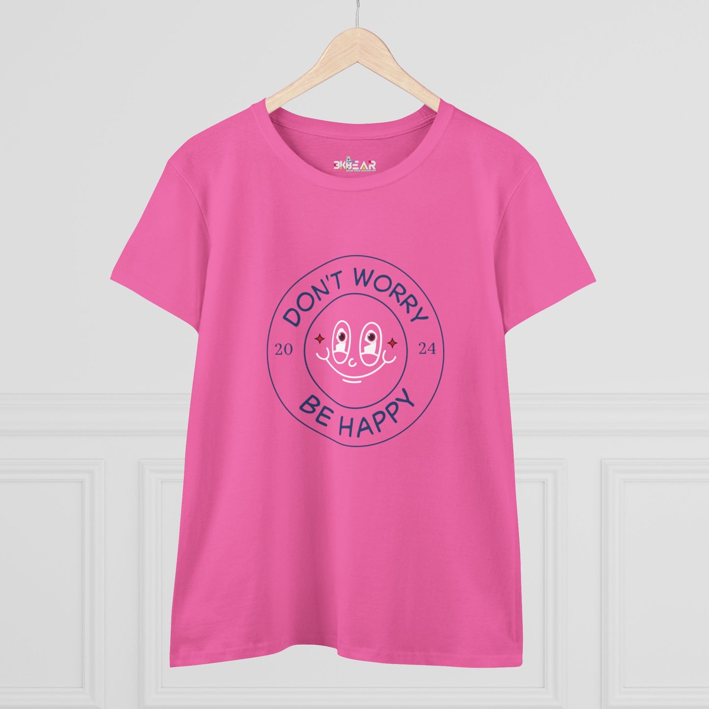 Pink Printify don’t worry be happy t-shirt with smiling face graphic on hanger