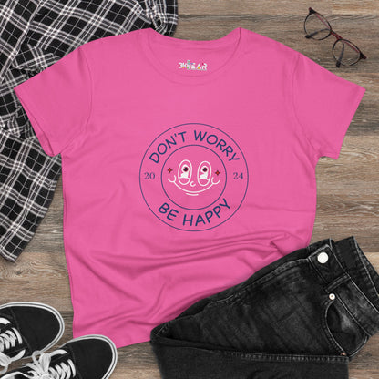 Pink don’t worry be happy t-shirt from Printify with smiling face graphic laid flat with black jeans and sneakers