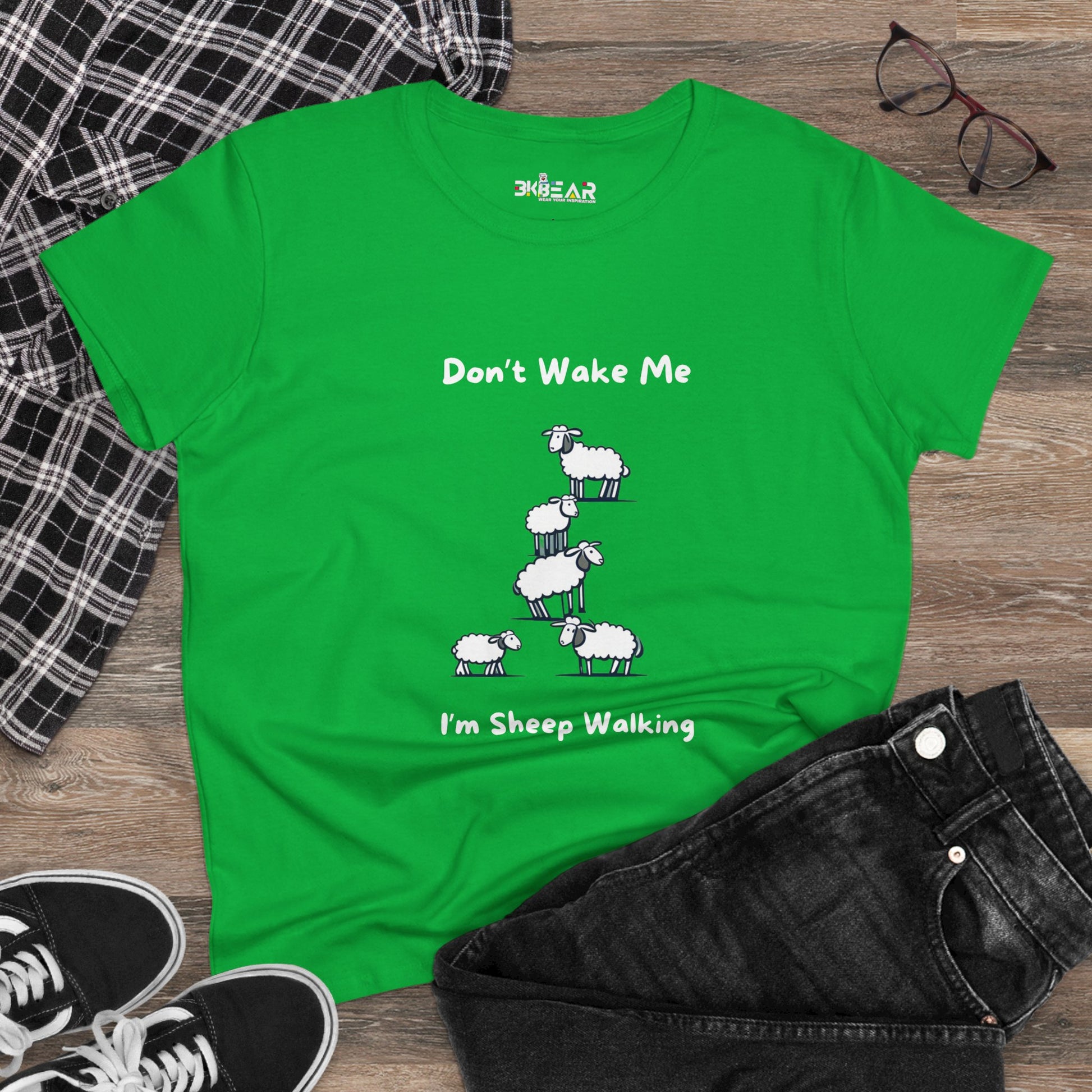 Green funny sheep graphic t-shirt with humorous text laid out with jeans and sneakers