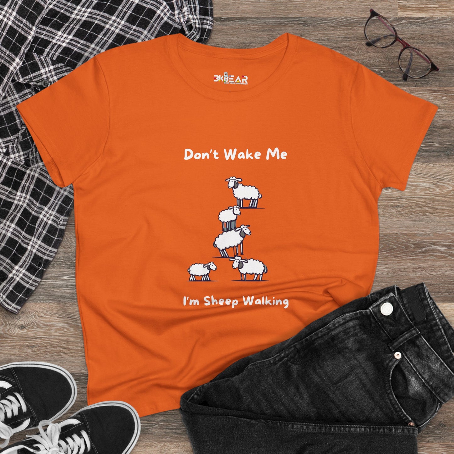 Orange funny sheep graphic t-shirt with playful sheep design and text Dont Wake Me Im Sheep Walking