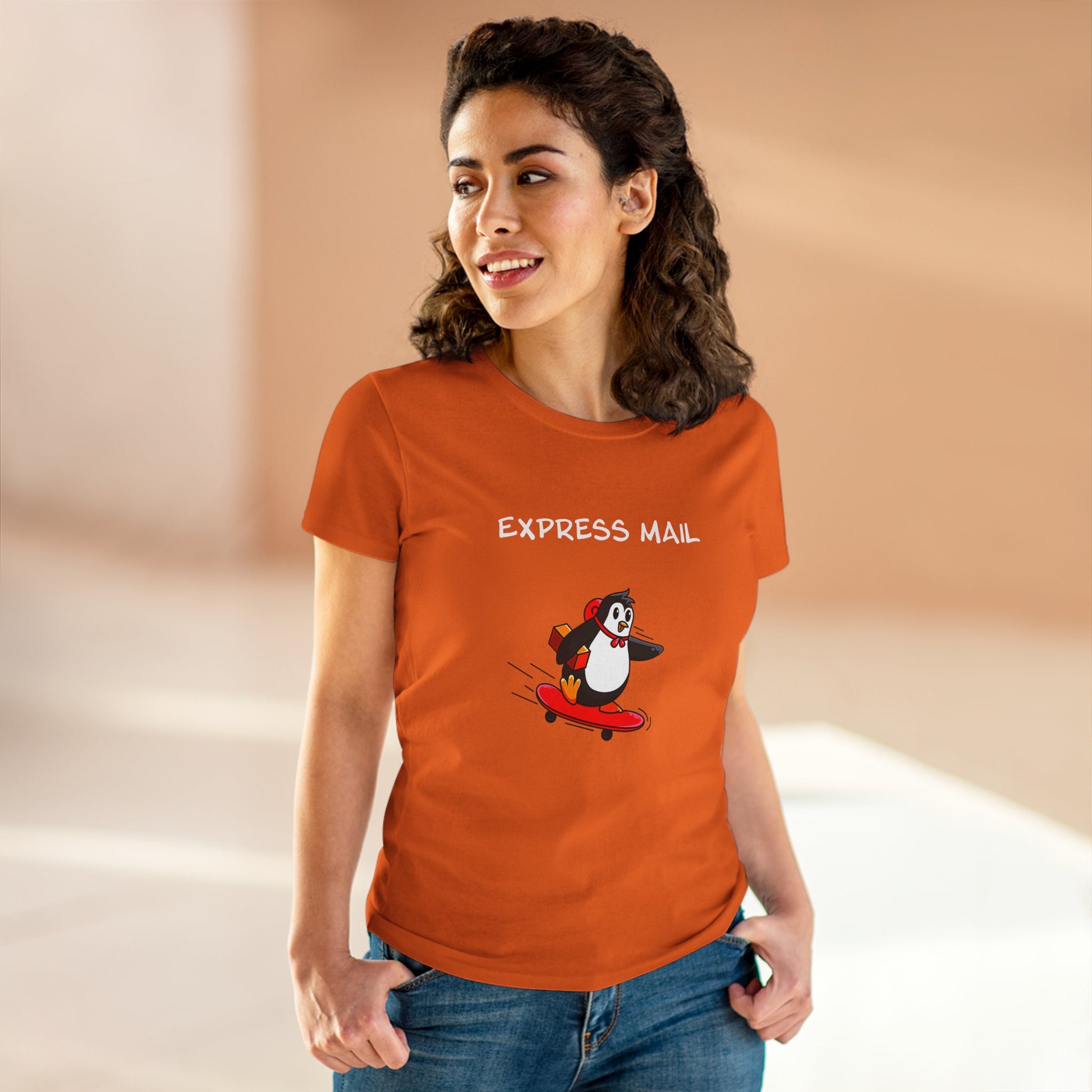 Orange penguin graphic tee with cartoon penguin on skateboard and express mail text, female model wearing