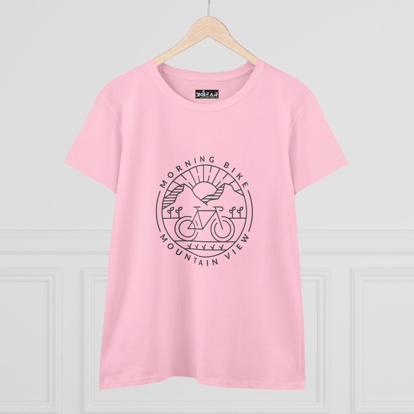 Pink Printify morning bike t-shirt with mountain view graphic on front on a hanger