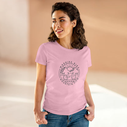 Woman wearing light pink Printify morning bike t-shirt with mountain bike graphic design
