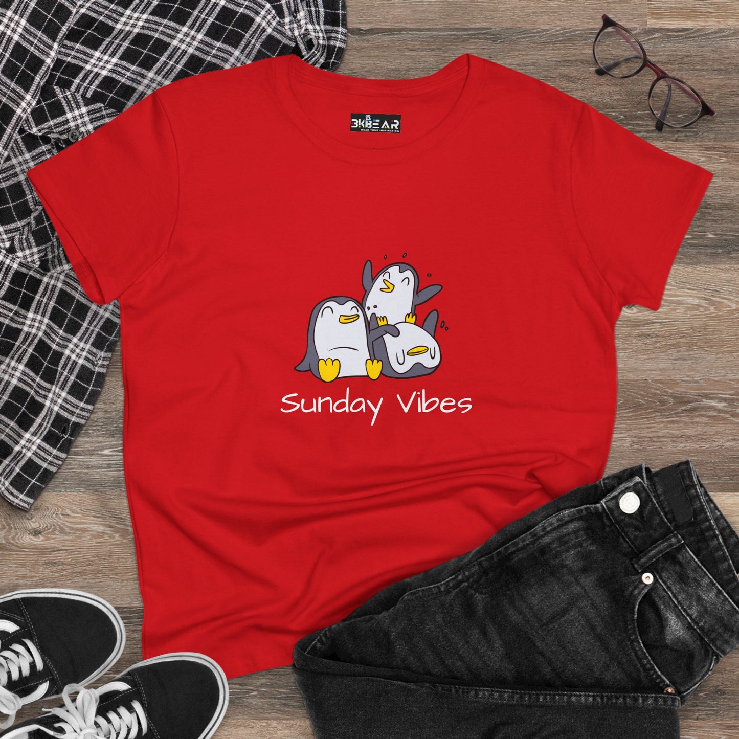 Red Printify sunday vibes graphic tee featuring three cartoon penguins on a wooden floor background