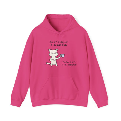 Pink but first coffee hoodie by Printify featuring cat holding coffee cup and humorous text