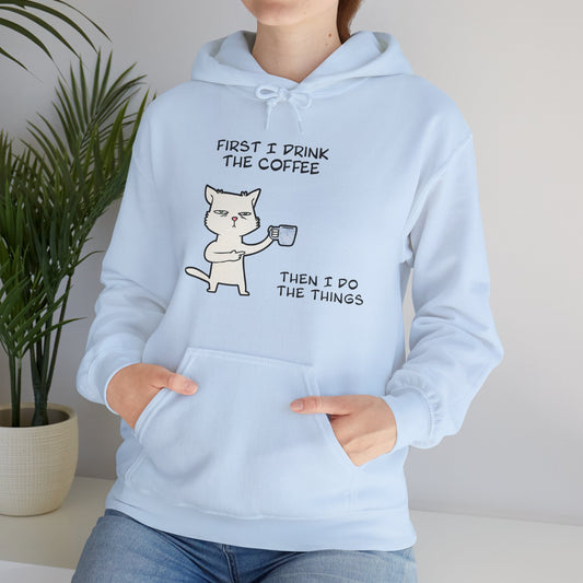 Printify but first coffee hoodie in light blue with a cat holding a coffee cup graphic