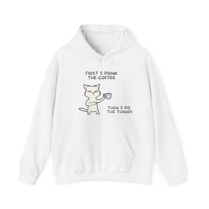 White but first coffee hoodie with cartoon cat holding a coffee mug and coffee quote