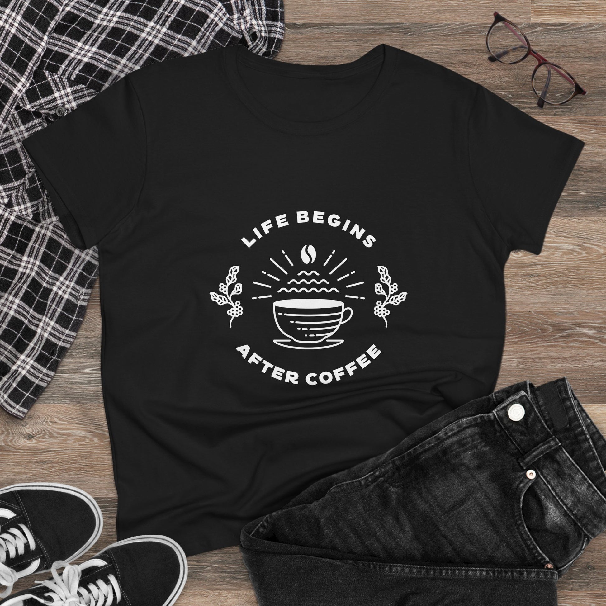 Black Printify but first coffee t shirt with Life Begins After Coffee design laid out with jeans and sneakers