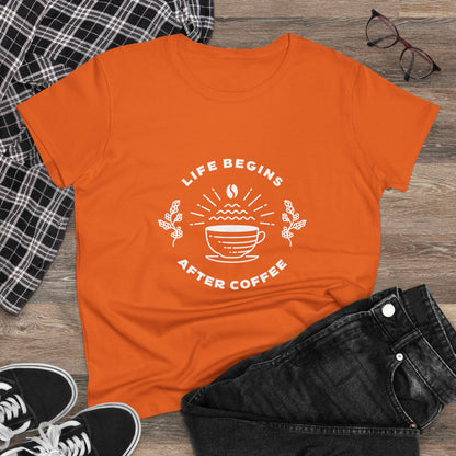 Orange but first coffee t shirt with white coffee cup design laid flat with black jeans and sneakers
