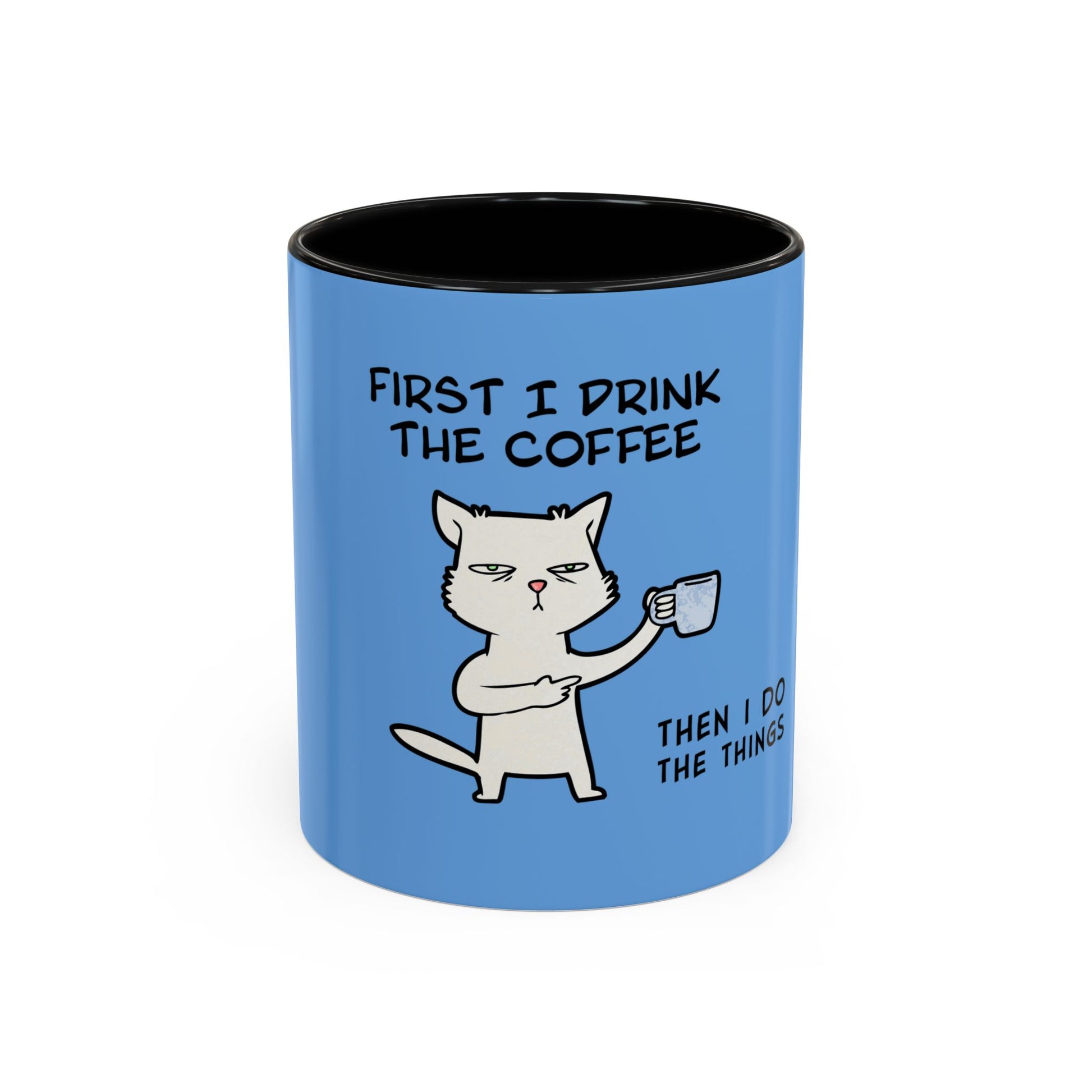 Blue coffee mug with black interior featuring a cartoon cat and text about drinking coffee and doing things