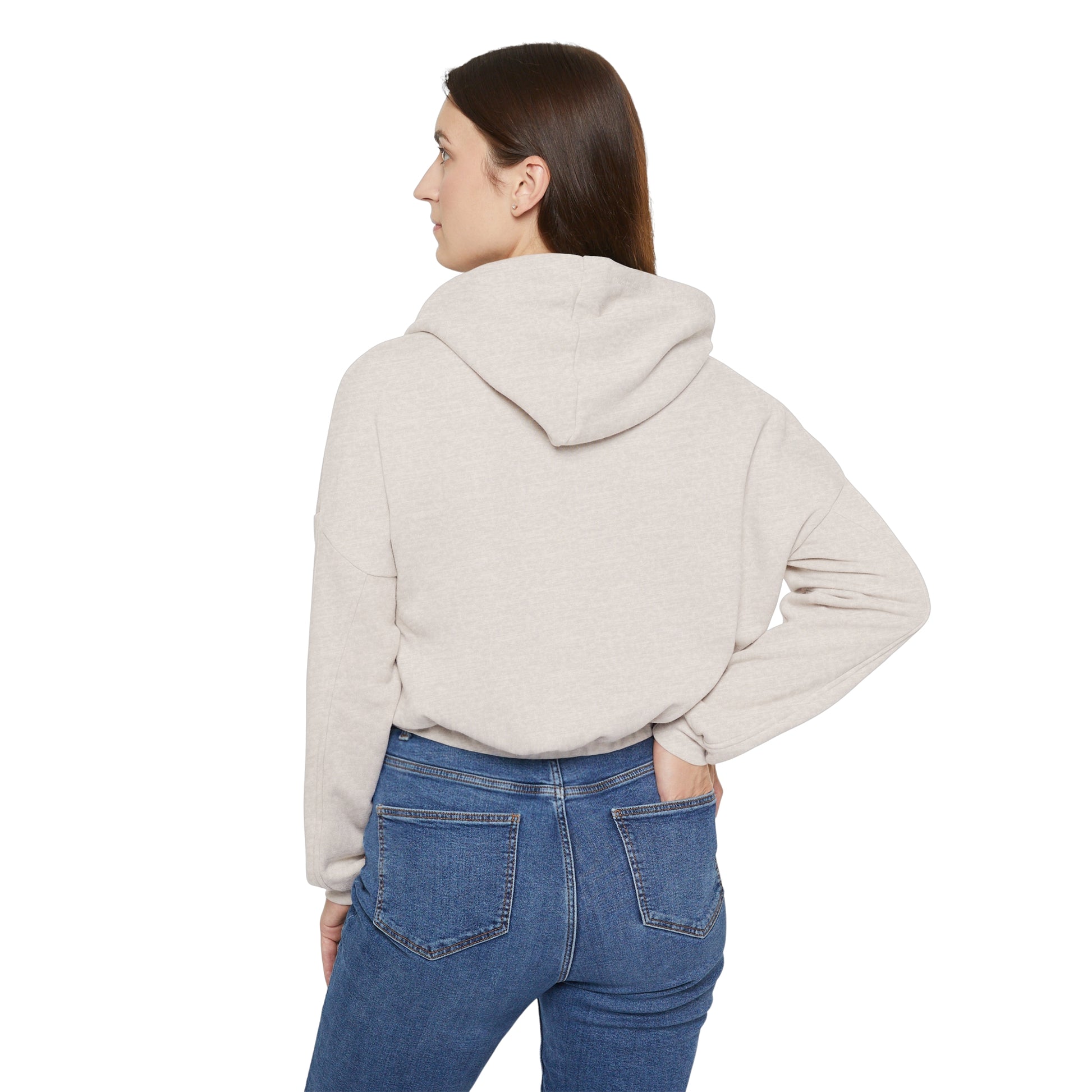 Back view of woman wearing a beige cinch women's hoodie paired with blue jeans