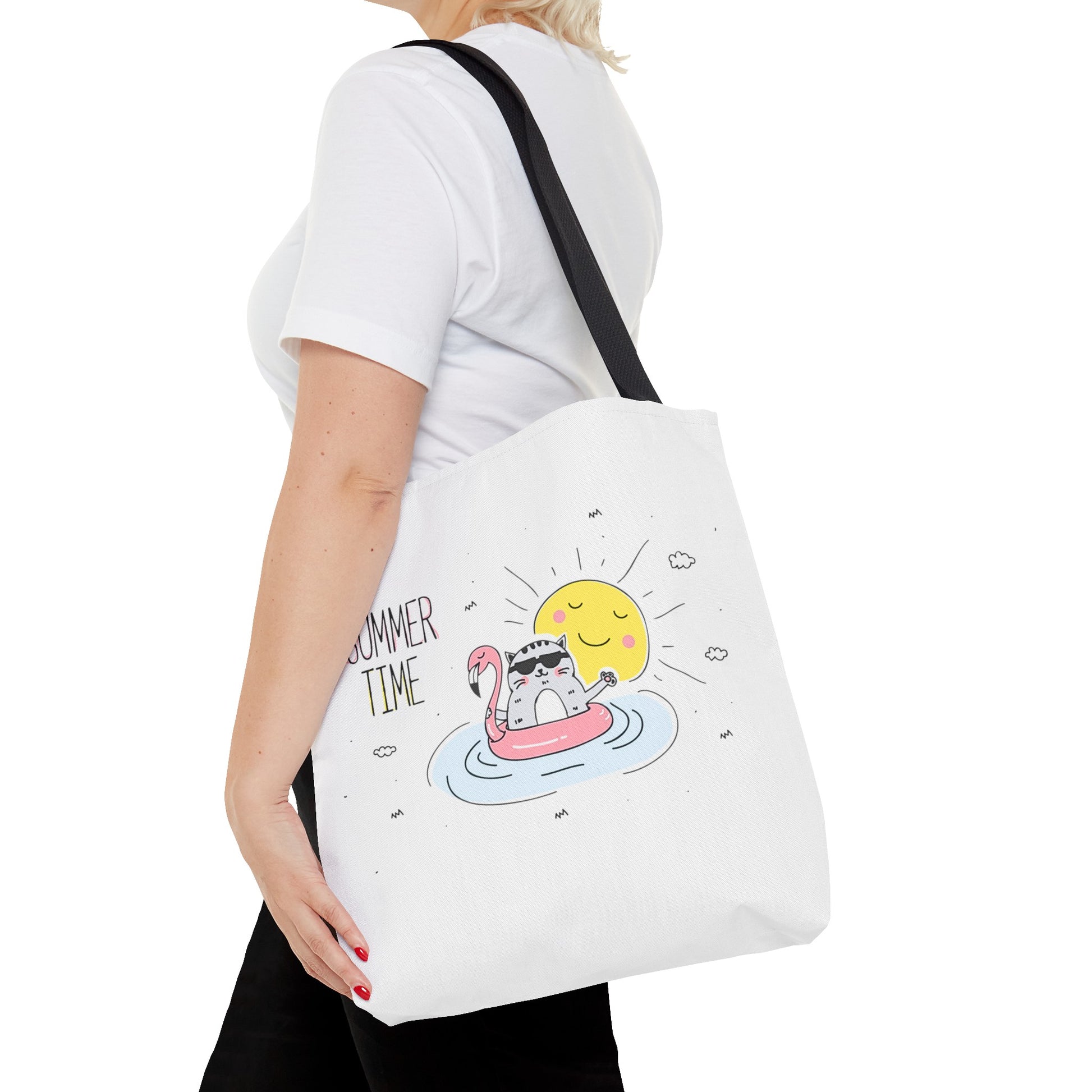 Printify cute animal graphic tote bag featuring a cat floating on an inflatable flamingo with a sun design