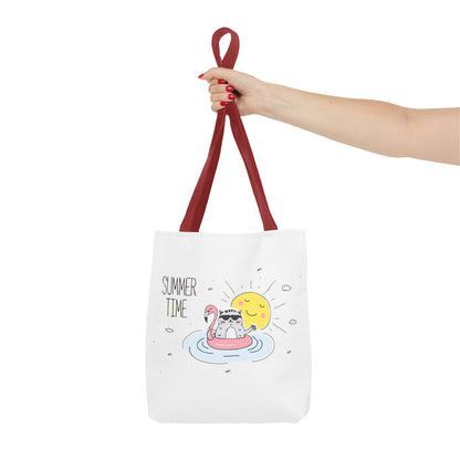 White cute animal graphic tote bag with red handles featuring a relaxing cat in a flamingo float and sunshine design
