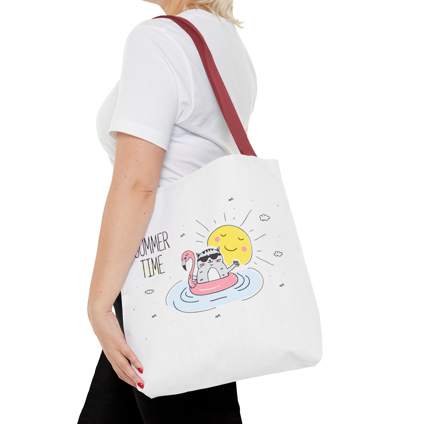 Printify cute animal graphic tote bag with cat on a float and sunshine design worn by woman