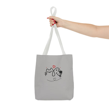 Printify cute dog lover tote bag with simple black and red dog and cat design held by hand