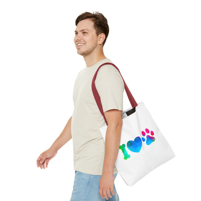 Man carrying a cute dog lover tote bag with colorful bone heart and paw print design