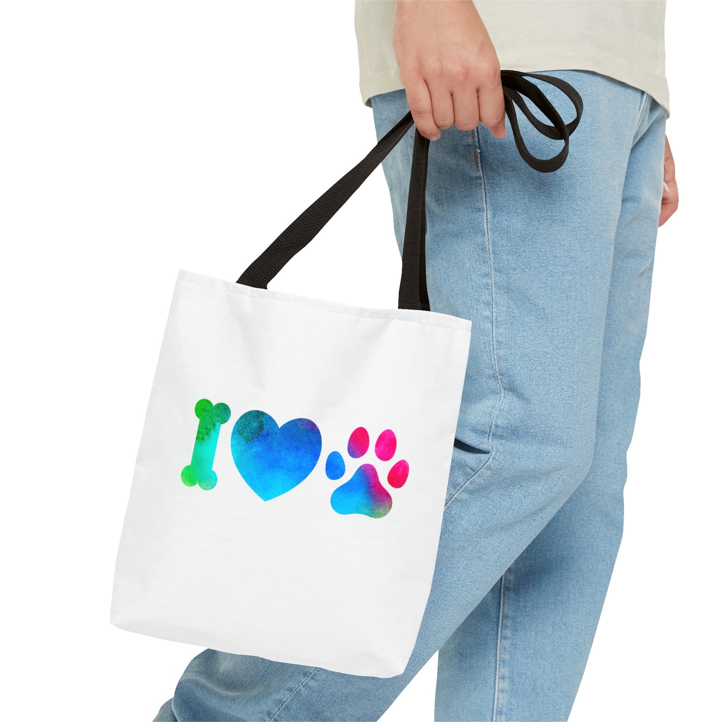 White cute dog lover tote bag with colorful bone heart and paw print design held by person
