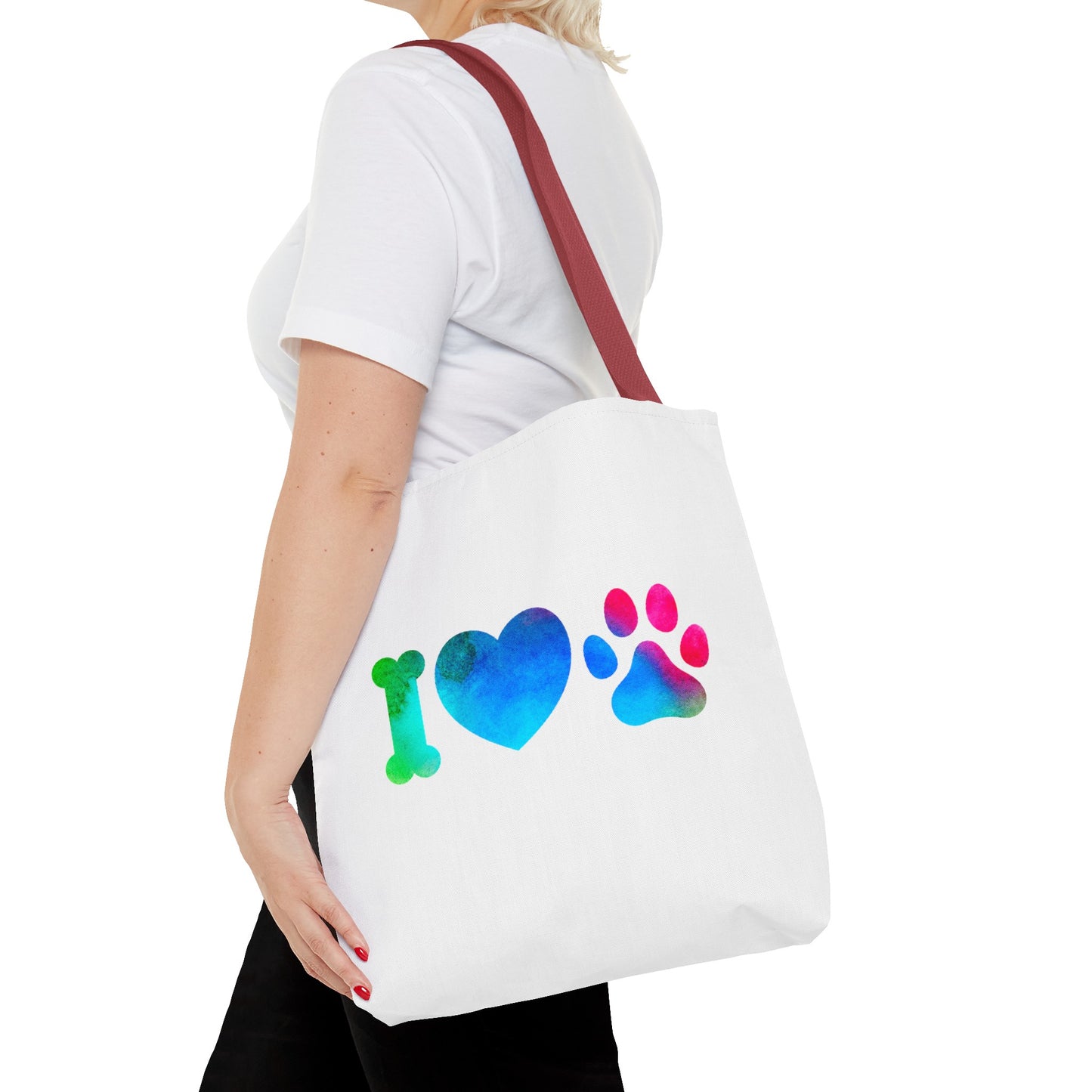 Cute dog lover tote bag with colorful bone heart and paw print design carried on shoulder