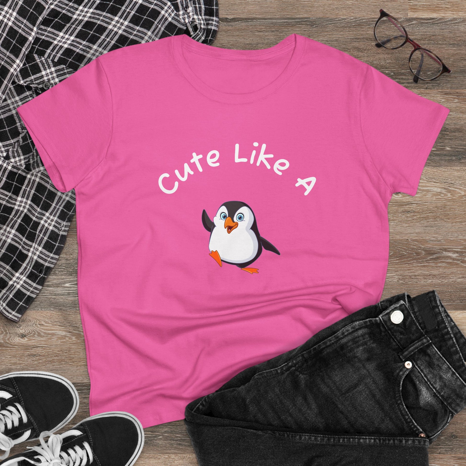 Pink penguin graphic t-shirt with Cute Like A text, paired with black jeans and shoes