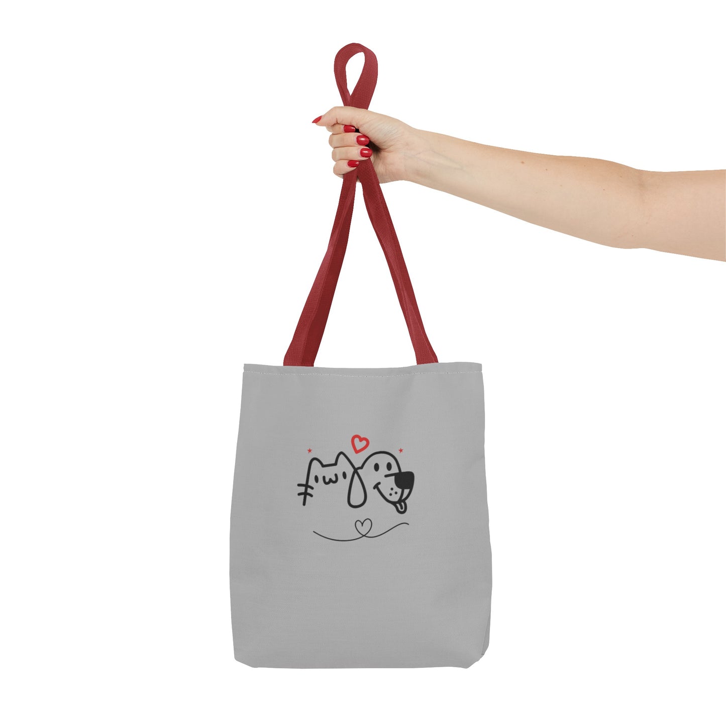 Printify cute puppy tote bag with red straps and cartoon dog and cat design held by hand