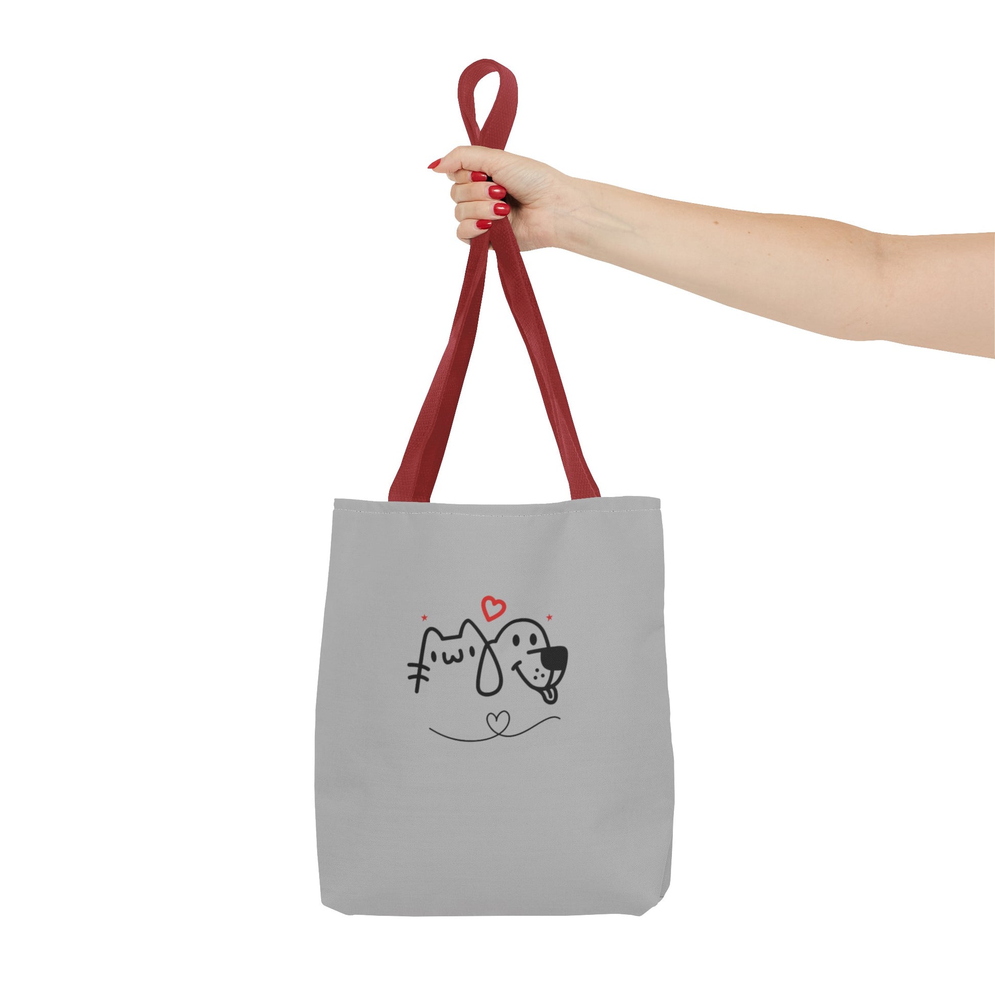 Printify cute puppy tote bag with red straps and cartoon dog and cat design held by hand
