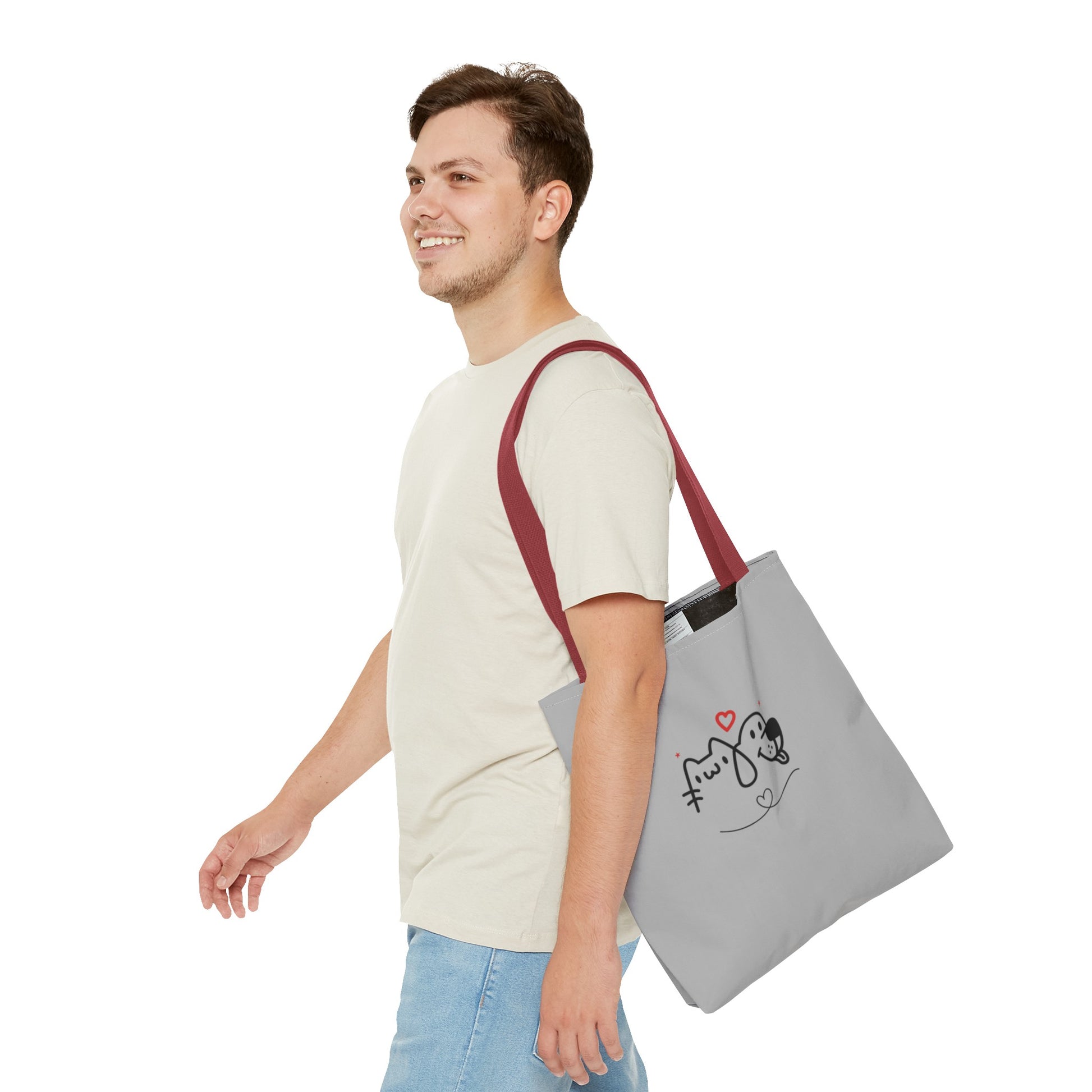 Man carrying a gray cute puppy tote bag with red straps featuring a simple dog and cat design