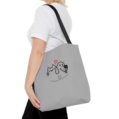 Woman carrying grey cute puppy tote bag with black handles and simple cartoon dog and cat design