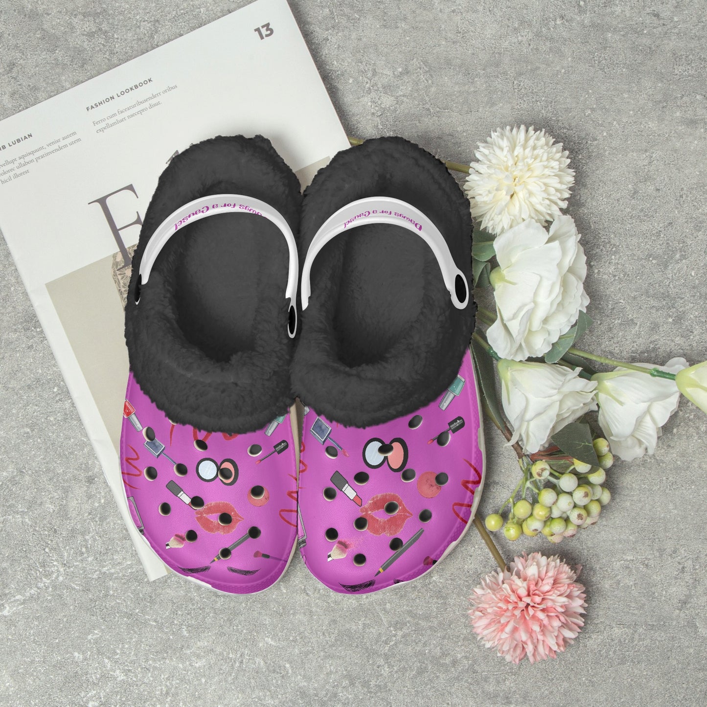 Fuzzy clogs for women in purple with black fur lining and white straps, decorated with lipstick and makeup designs