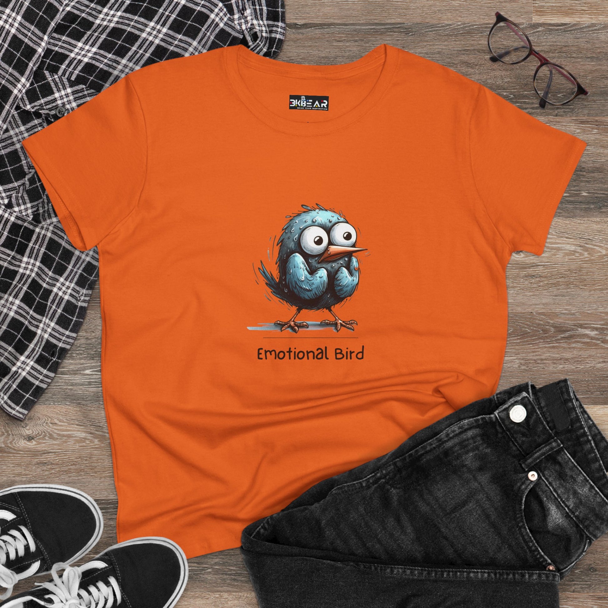 Orange emotional bird tee from Printify featuring a cute blue cartoon bird with big eyes on front