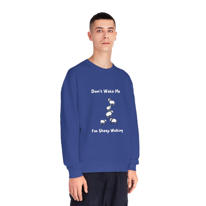 Man wearing a blue funny sheep sweatshirt with white sheep graphic and text saying Don't Wake Me I'm Sheep Walking