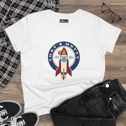 White funny space graphic shirt with colorful rocket and text that's nutty laid flat with black jeans and plaid shirt