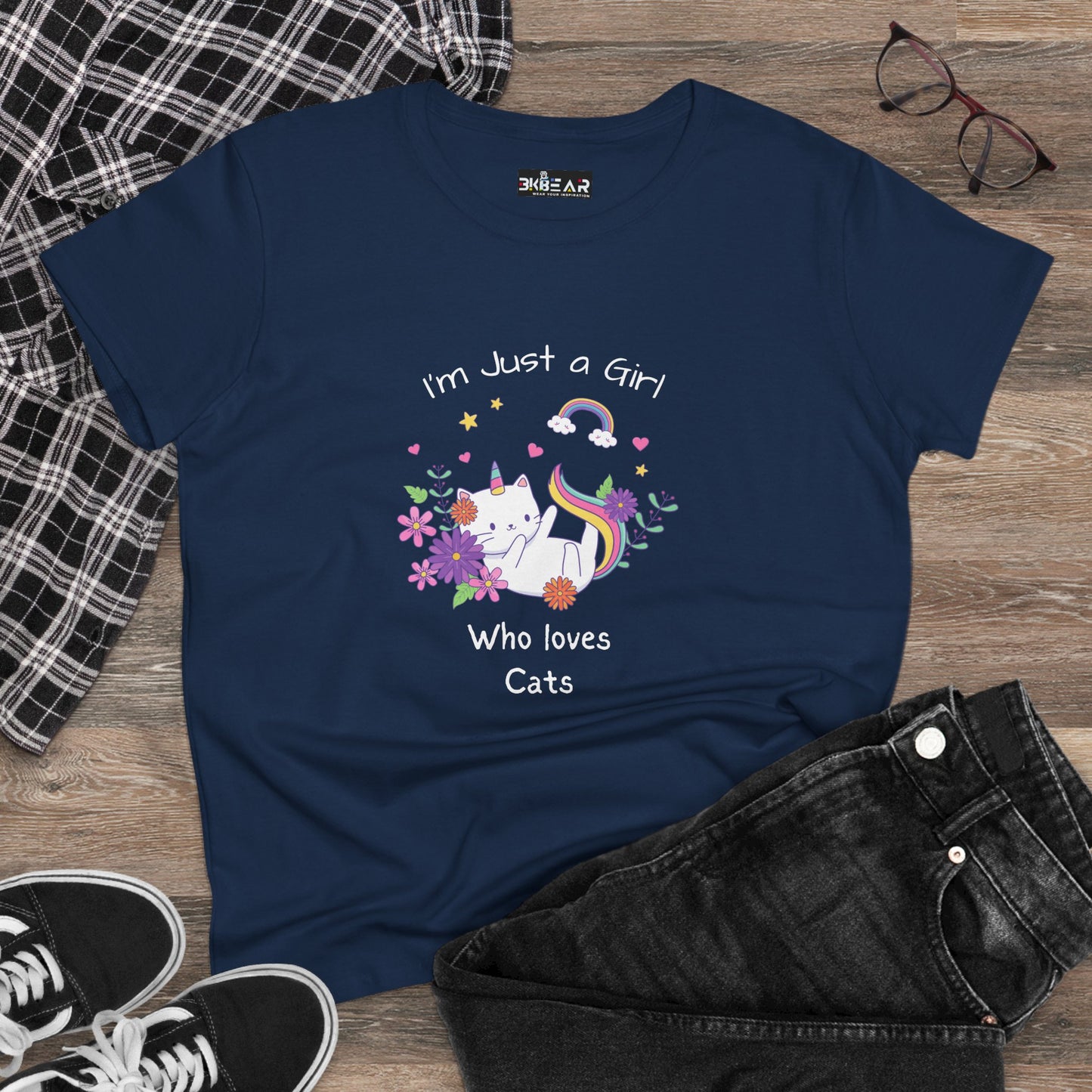 Navy girl who loves cats t-shirt with colorful cat and floral design laid out with glasses shoes and jeans