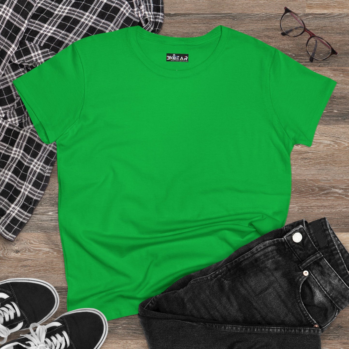 Green heliconia t-shirt women laid flat with black jeans plaid shirt and sneakers