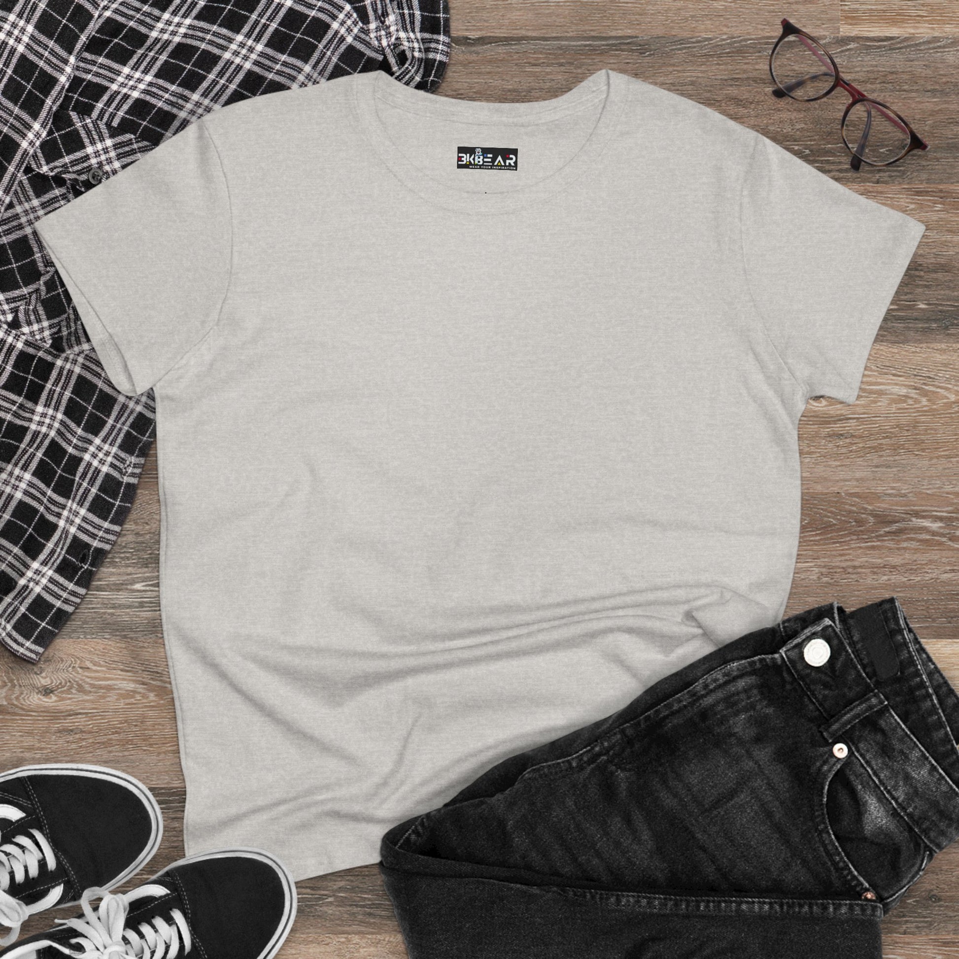 Plain light gray heliconia t-shirt women styled with black jeans black sneakers and a checkered shirt