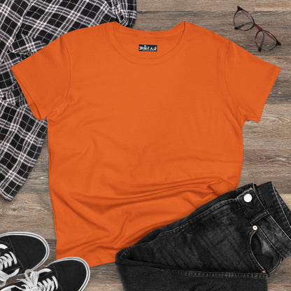 Orange heliconia t-shirt women styled with black jeans, black and white sneakers, and a plaid shirt