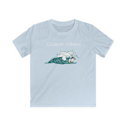 Light blue kids ocean vibes t-shirt with a surfing wave graphic and Ocean Vibes text