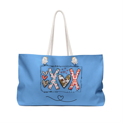 Printify love graphic weekender bag in blue with decorative XOX heart design and white rope handles