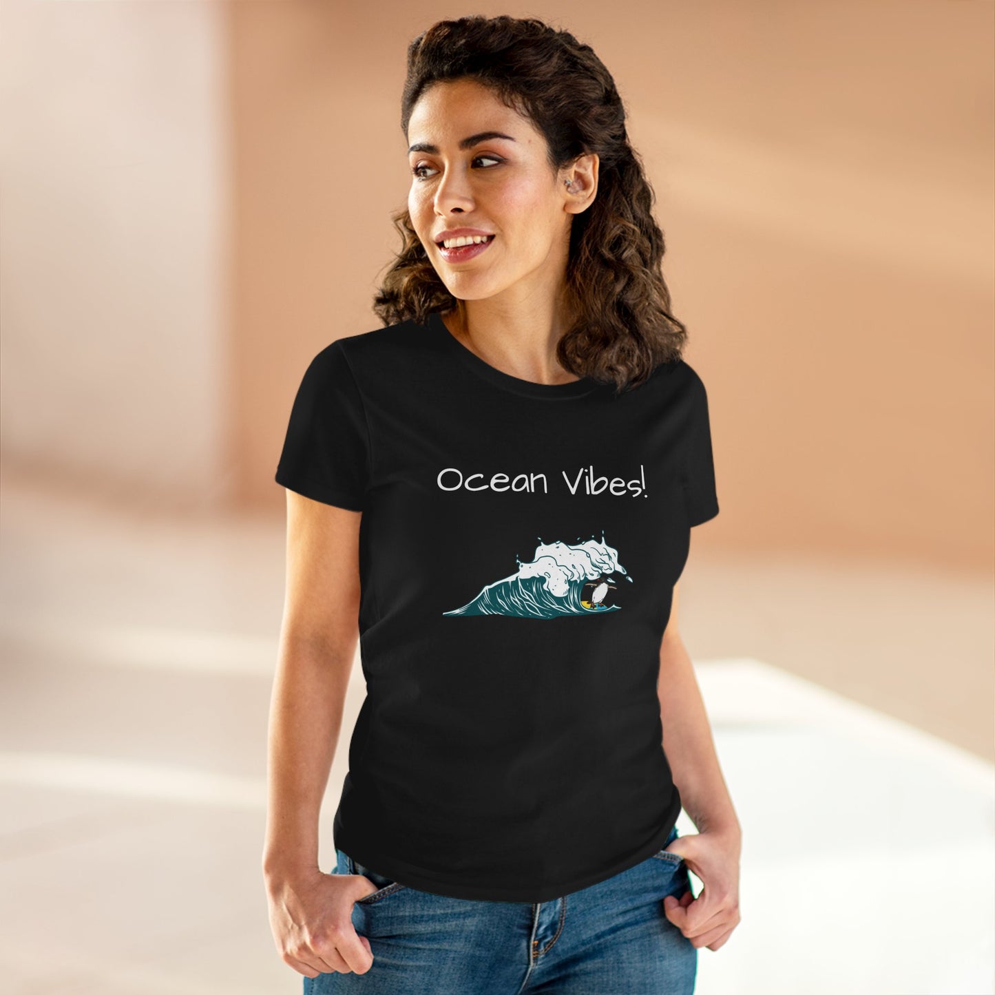 Woman wearing a black Printify beach graphic tee with ocean wave and Ocean Vibes text