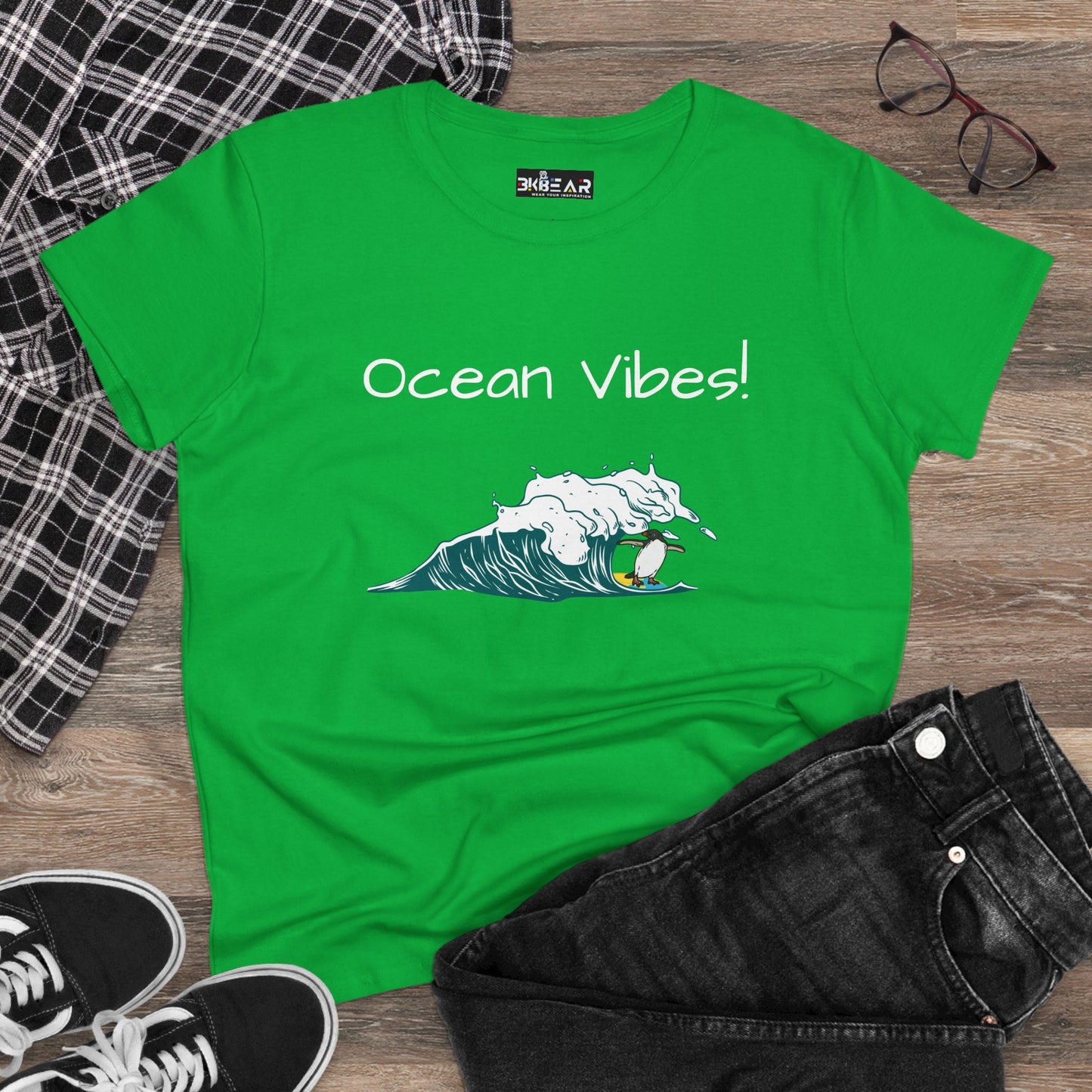 Green Printify T-shirt with ocean vibes beach graphic tee design featuring wave and surfer illustration