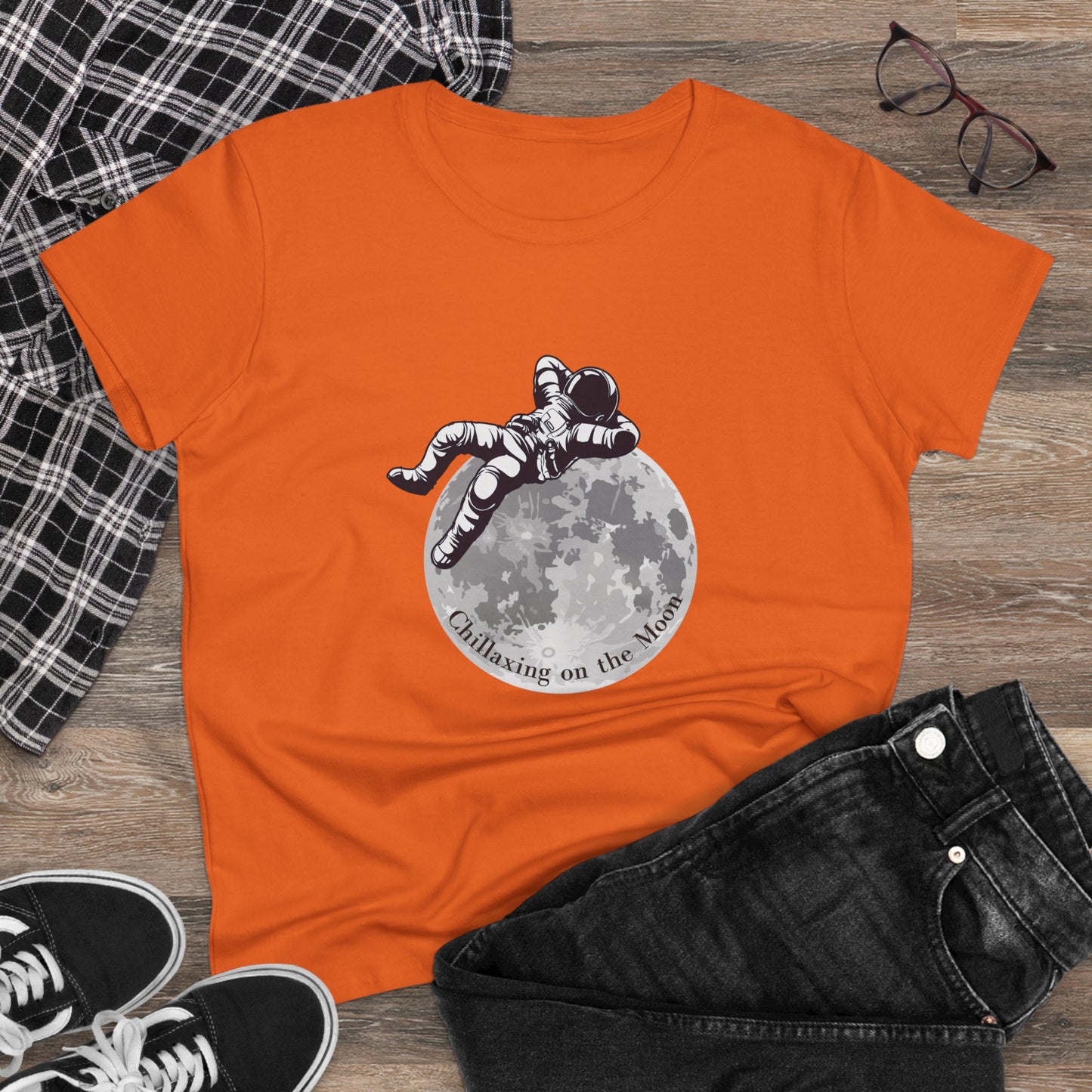 Orange moon t-shirt women featuring astronaut relaxing on the moon graphic design