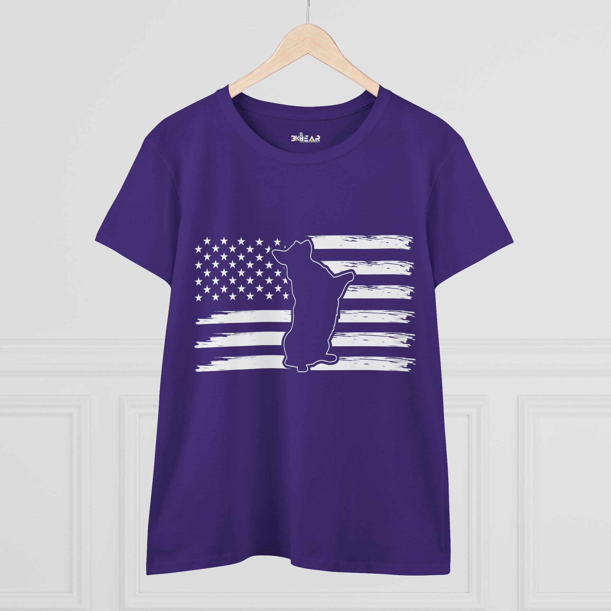 Purple patriotic dog t-shirt with white American flag and dog silhouette print hanging on wooden hanger