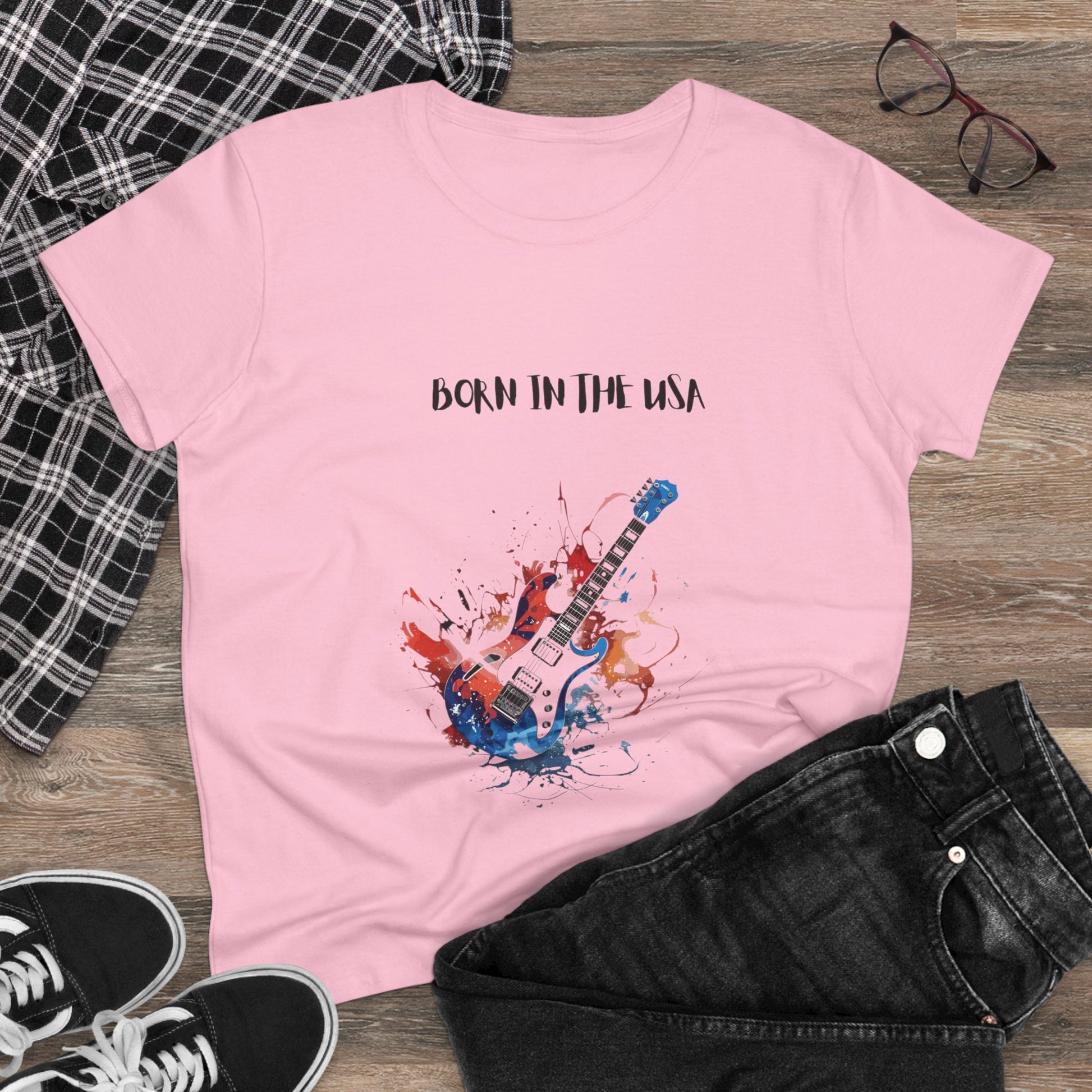 Pink patriotic guitar tee with Born in the USA design laid out with black jeans and sneakers