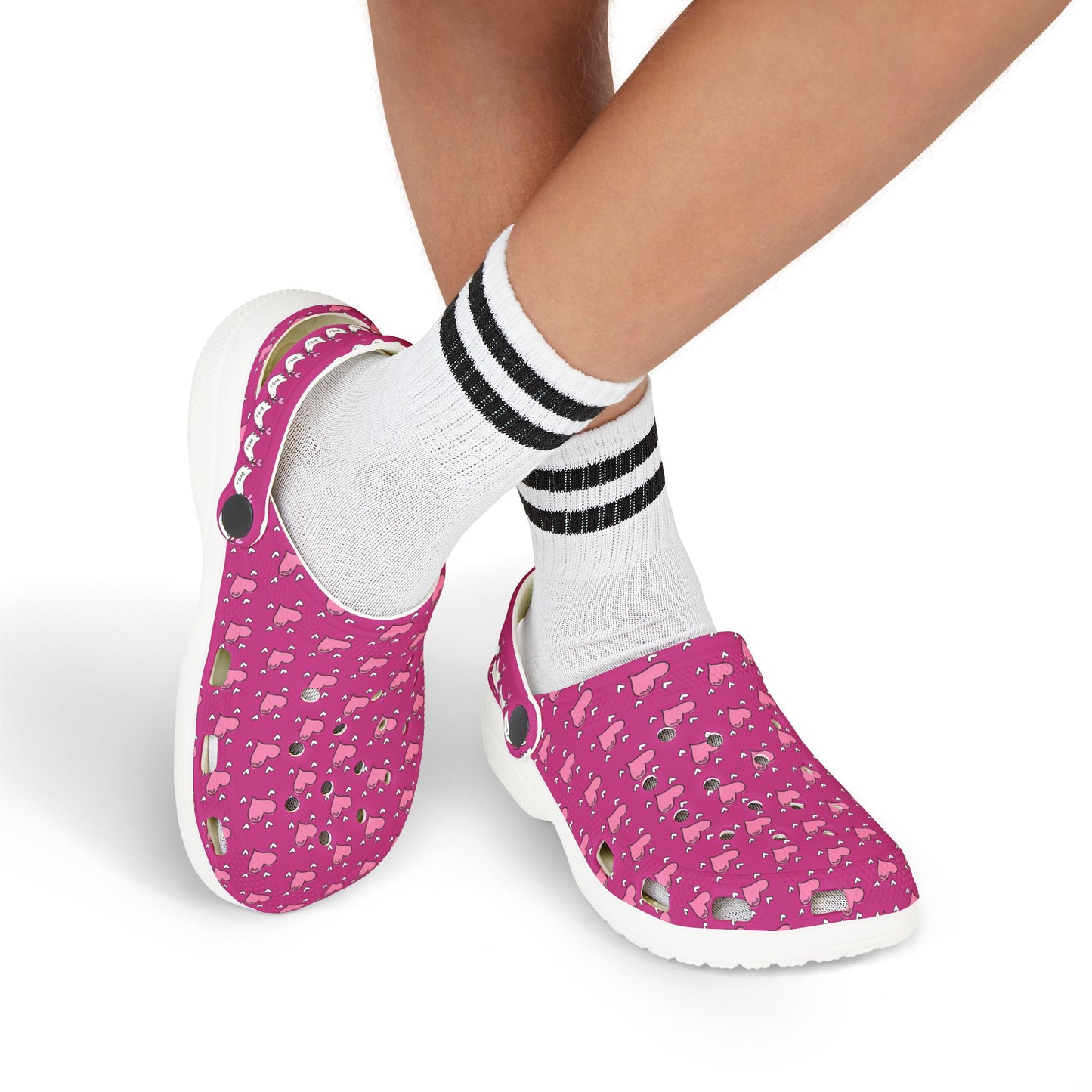 Pink rubber clogs with white soles worn with white socks featuring black stripes