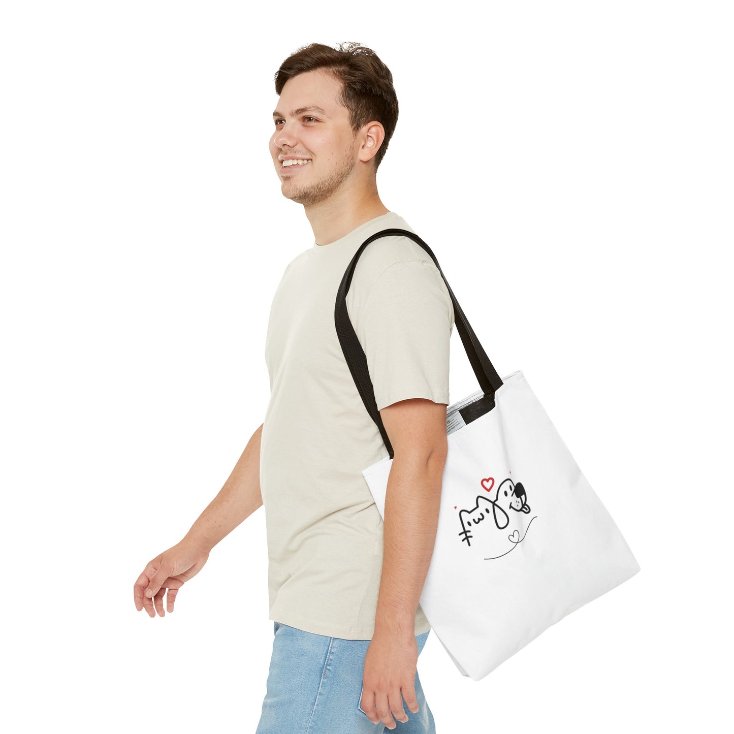Man wearing a white puppy love graphic tote with black straps featuring a cute dog and cat design