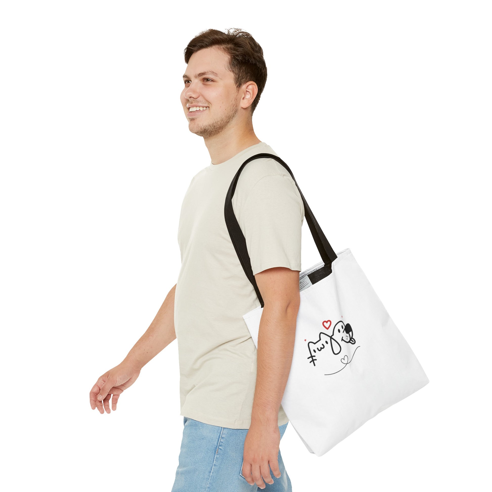 Man wearing a white puppy love graphic tote with black straps featuring a cute dog and cat design