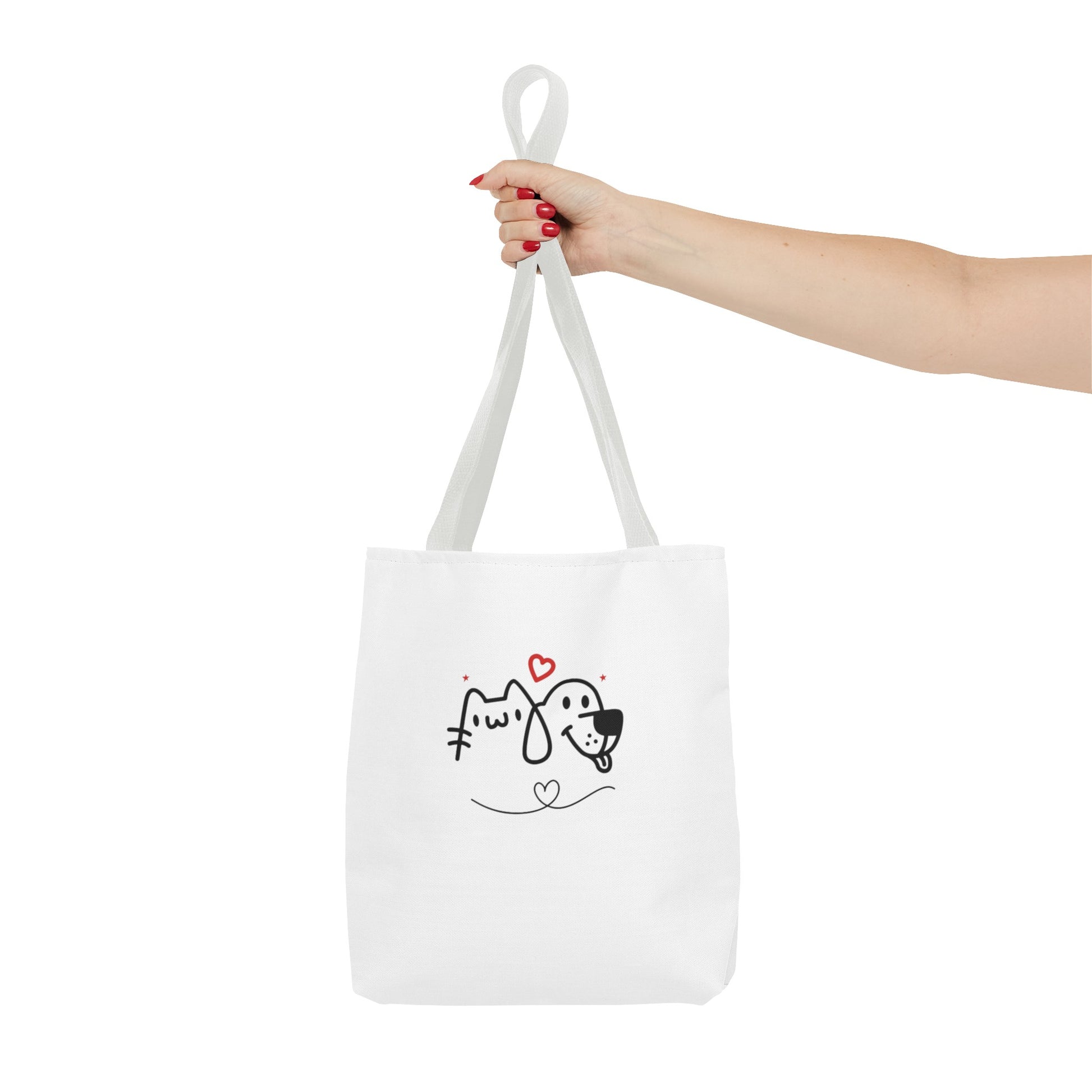 White puppy love graphic tote bag with cute dog and cat design held by hand